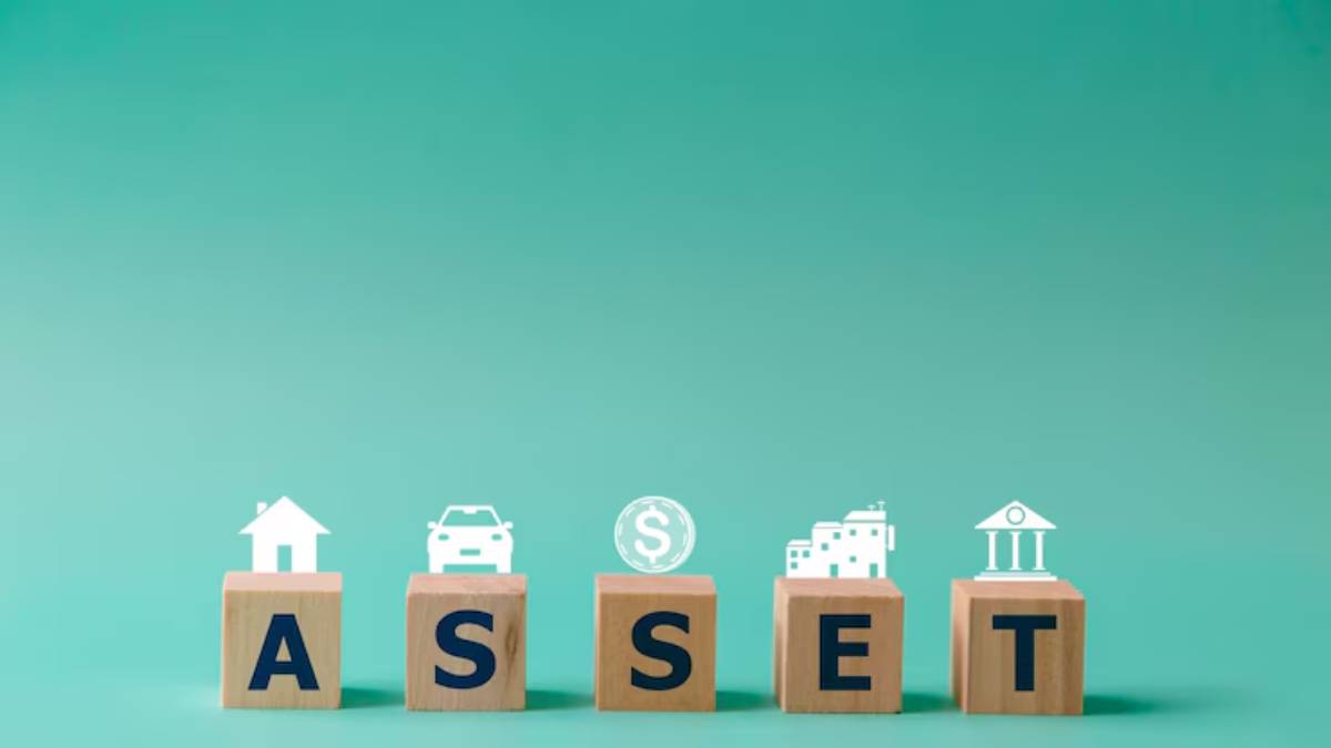 Wooden blocks spell ASSET with icons representing a house, car, money, building, and bank, set against a teal background.