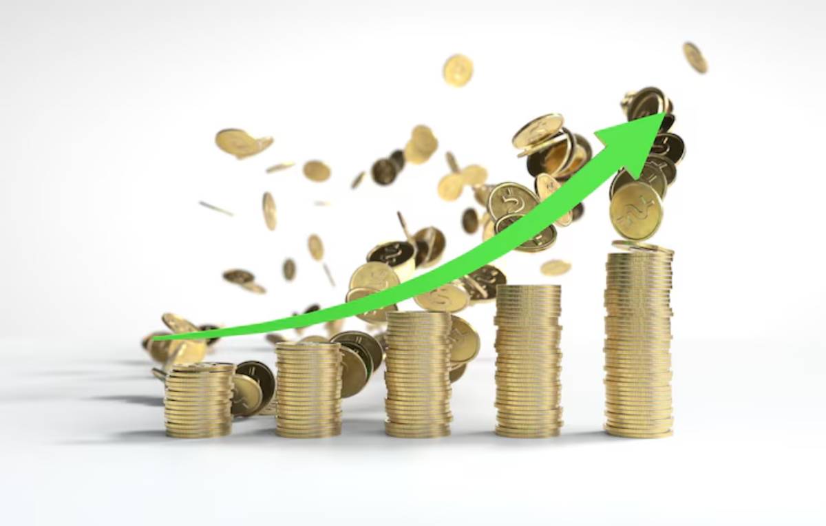 Stacks of gold coins with a rising green arrow, representing financial growth, surrounded by scattered coins.