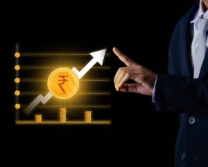 A businessman points to a rising graph with a coin symbolizing currency, indicating financial growth and investment success.