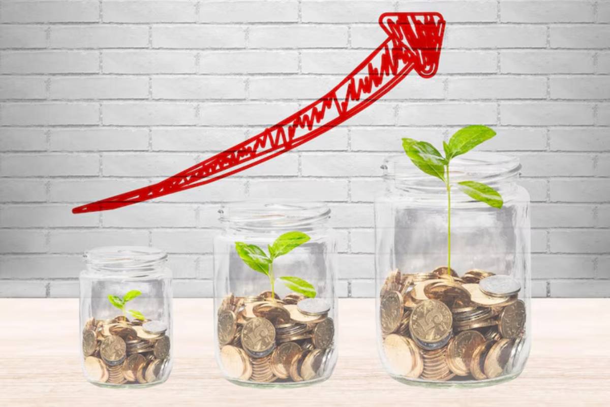Three glass jars filled with coins and plants, with a red upward arrow illustrating growth against a brick wall background.