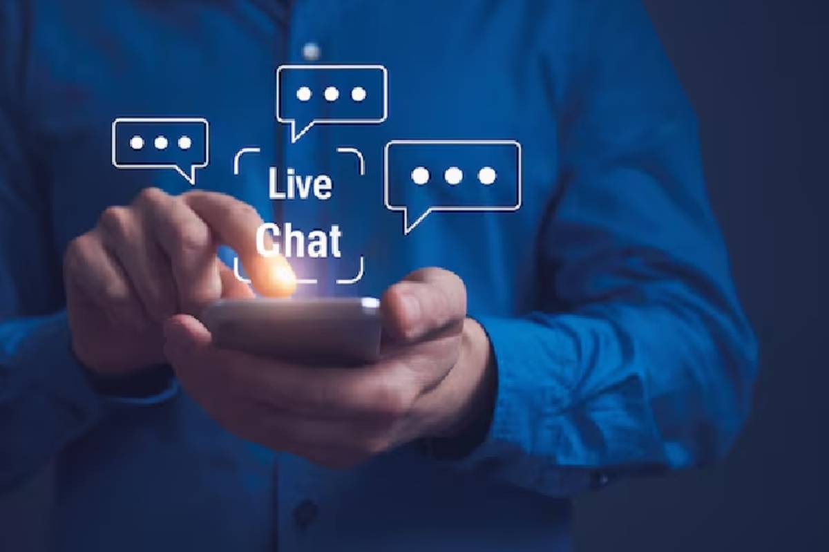 Person in a blue shirt using a smartphone to engage in live chat, with chat bubbles illustrating the conversation.