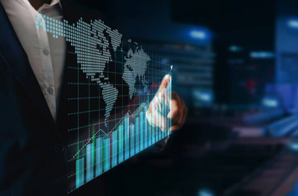 A business professional interacts with a digital financial graph and world map, indicating growth and data analysis in a modern setting.