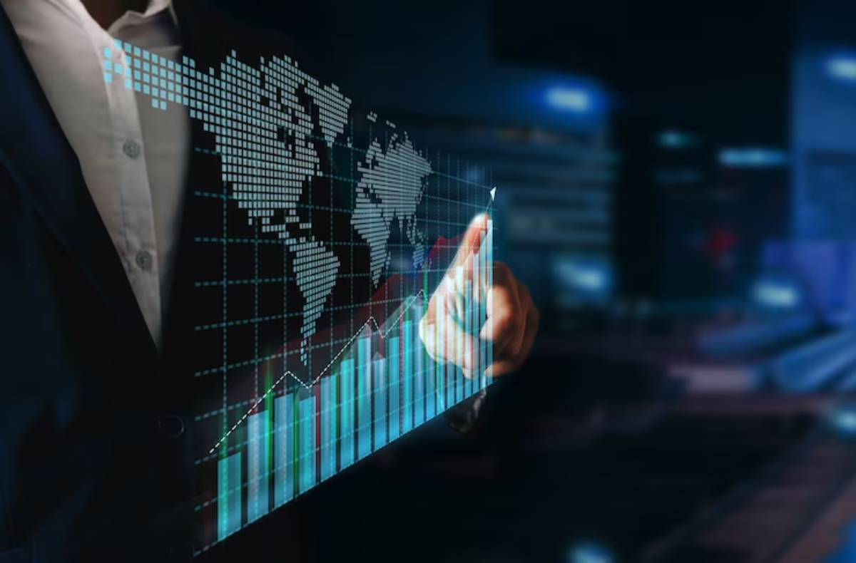 A business professional interacts with a digital financial graph and world map, indicating growth and data analysis in a modern setting.
