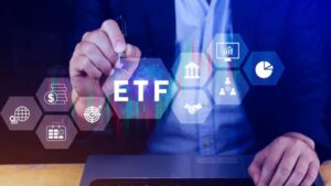 A businessman writing ETF surrounded by financial icons on a digital interface, symbolizing investment and market analysis.