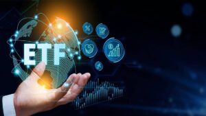 A hand holds a glowing globe with ETF text, surrounded by digital finance icons and graphs on a dark background.