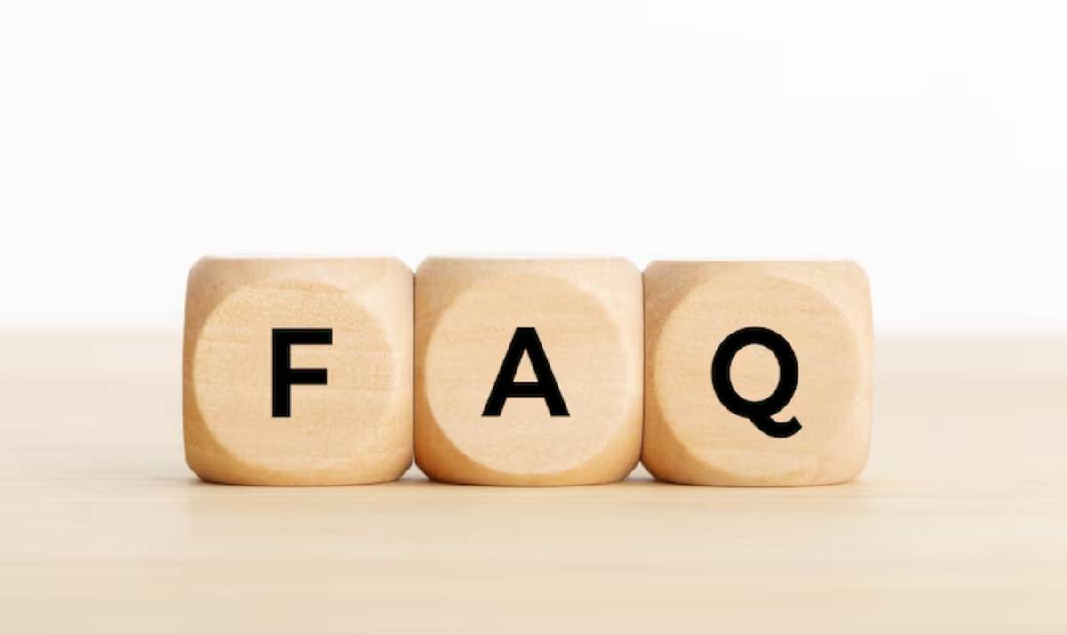 Three wooden blocks displaying the letters representing an acronym for Frequently Asked Questions.