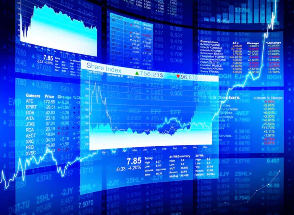 A digital stock market display with blue background, showing graphs, share indices, and price changes for various stocks and currencies.