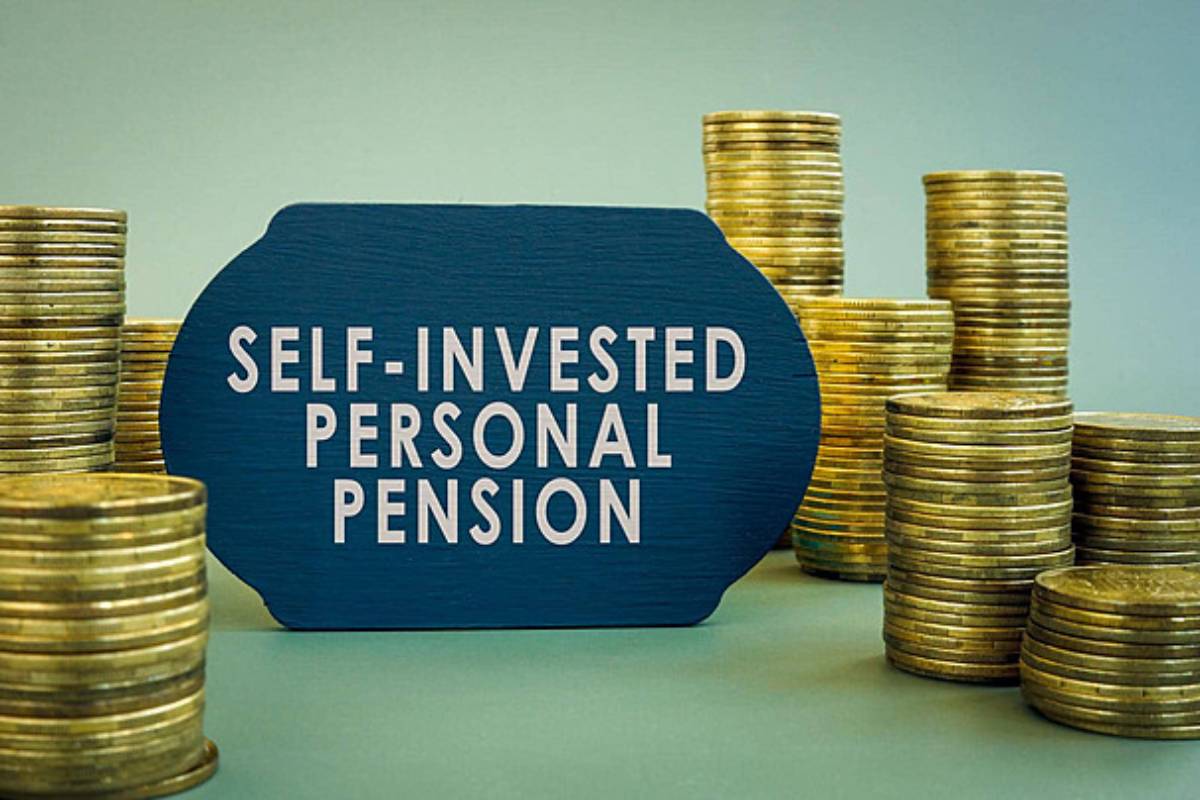 A blue sign reading SELF-INVESTED PERSONAL PENSION surrounded by stacks of gold coins on a gradient background.