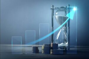 A silver hourglass beside stacks of coins, with a rising graph overlay symbolizing time and financial growth.